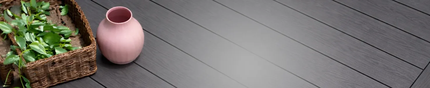 Charcoal grey composite decking boards with modern wood grain texture